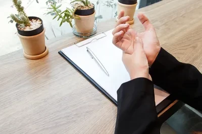 Person holding wrist showing signs of repetitive strain injury