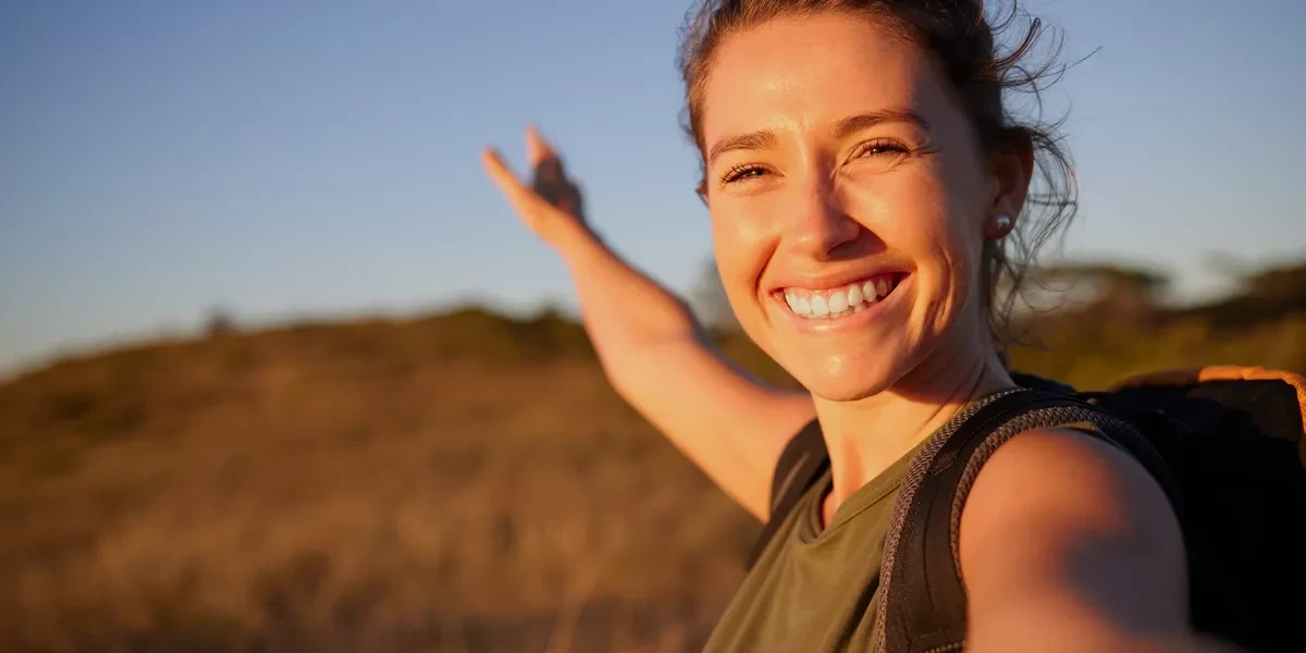 Smiling woman outdoors — healthy mind and body daily checklist